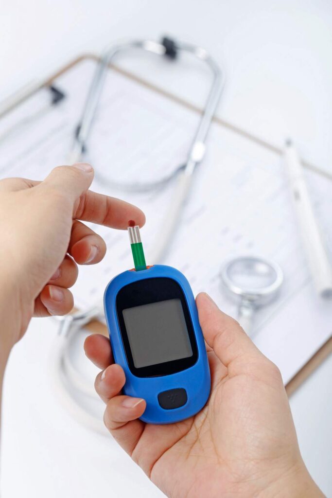 hand-holding-blood-glucose-meter-measuring-blood-sugar